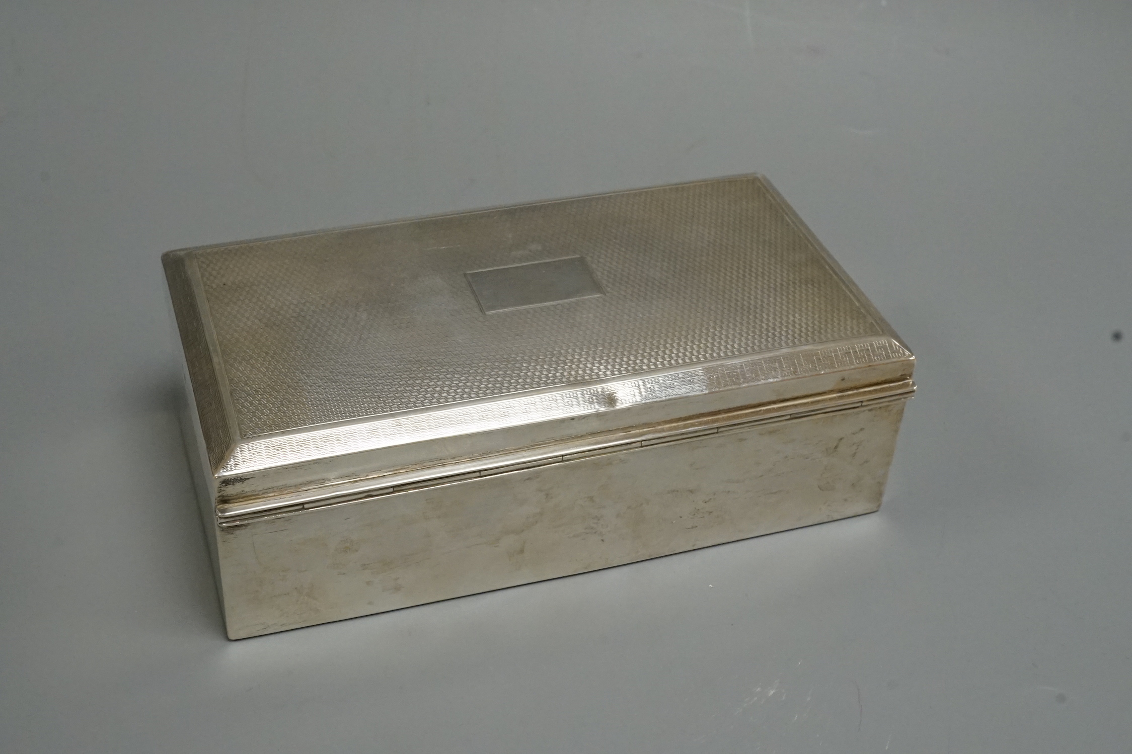 A George V silver mounted rectangular cigarette box, Birmingham, 1928, 17.2cm.